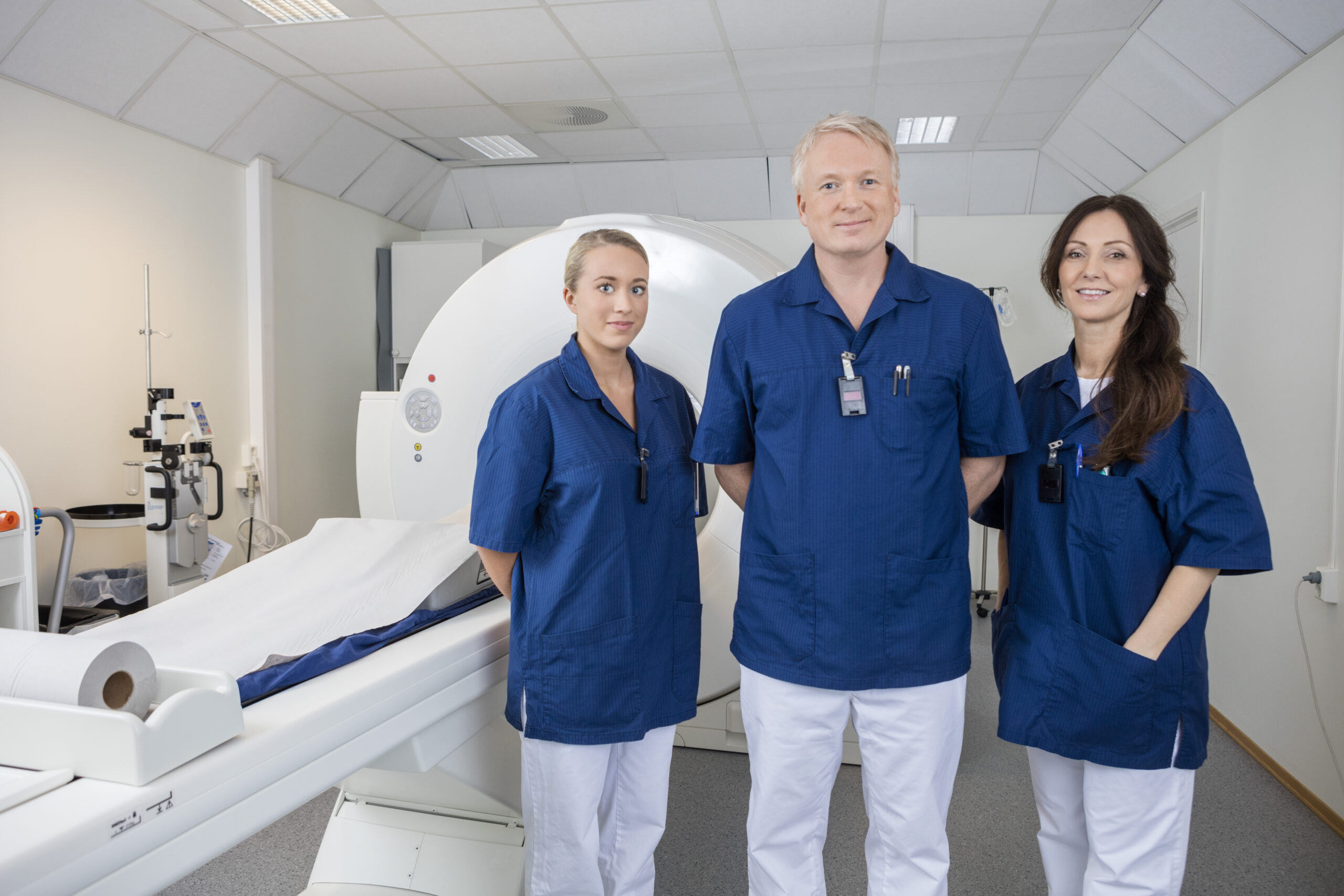 Confident Medical Team Smiling by MRI Machine